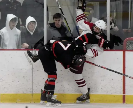  ?? JIM MICHAUD / HERALD STAFF ?? LAYING THE WOOD: Pope Francis’s Ryan Hemenway, left, crashes into Arlington’s Leonidas Piandes during Monday’s game at Burns Arena in Arlington,