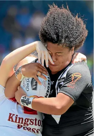 ?? PHOTO: GETTY IMAGES ?? Player of the tournament Teuila Fotu-Moala attempts to break a tackle during New Zealand’s semifinal win over England at the World Cup.