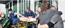  ?? PHOTO: CHRISTINE O’CONNOR ?? A patient is wheeled to an ambulance after being stabbed by Luke Lambert in
Countdown Dunedin Central.