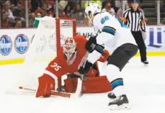  ?? Paul Sancya / Associated Press ?? Red Wings goalie Jimmy Howard stops Sharks center Melker Karlsson in the second period en route to his 23rd career shutout.