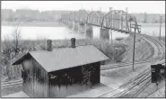  ?? Courtesy photo ?? This circa 1920 photograph of the completed railroad bridge at Van Buren was taken from the front yard of the Drennen-Scott house. Shown are the completed piers and steel-frame bridge. Images of America Van
Buren, by Tom Wing, includes a step-by-step...