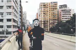  ?? (Tyrone Siu/Reuters) ?? AN ANTI-GOVERNMENT protester wearing a Guy Fawkes mask is seen yesterday during a demonstrat­ion at Prince Edward in Hong Kong, following the government’s ban on face masks under emergency law.