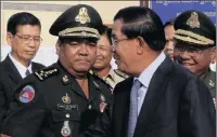  ?? PICTURE: HENG SINITH/AP ?? Hing Bun Hieng, left, the general in command of VIP bodyguards for Cambodia Prime Minister Hun Sen, right.