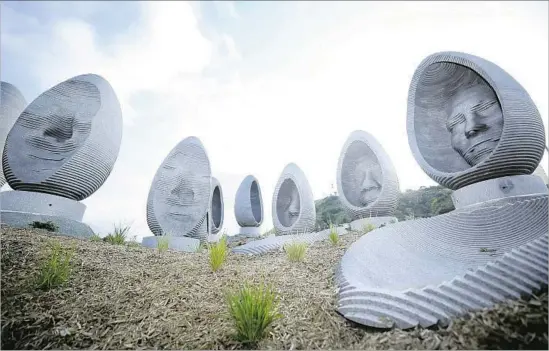  ?? Mariah Tauger For The Times ?? LOCAL RESIDENTS and sustainabl­e landscapes are given tribute in the installati­on “Faces of Elysian,” created by Greenmeme’s Freyja Bardell and Brian Howe.