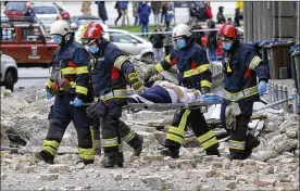  ?? ASSOCIATED PRESS ?? Firefighte­rs carry a person on a stretcher after an earthquake in Zagreb, Croatia, Sunday. A strong earthquake shook Croatia and its capital on Sunday, causing widespread damage and panic. Prime Minister Andrej Plenkovic said the earthquake was the biggest in Zagreb in the last 140 years.