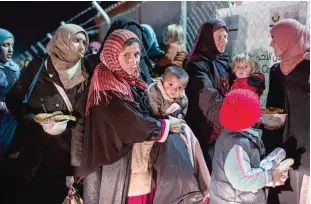  ?? —AFP ?? HASAN SHAM, Iraq: This file photo taken on December 16, 2016 shows displaced Iraqi women and children from the embattled city of Mosul arriving at the Sewdinan camp for internally displaced persons.