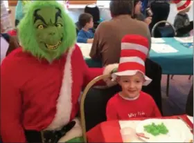  ?? GLENN GRIFFITH — MEDIANEWS GROUP ?? The Grinch poses for a photo with Eli St. John, 6, at the Cohes-Waterford Elks celebratio­n of Dr. Seuss’ birthday on Saturday.