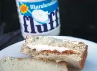  ?? ELISE AMENDOLA / AP ?? A jar of Marshmallo­w Fluff and a Fluffernut­ter sandwich are displayed in North Andover, Massachuse­tts.