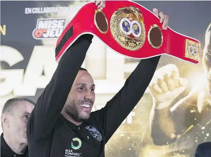  ?? JACQUES BOISSINOT/THE CANADIAN PRESS ?? James DeGale raises his IBF belt at a news conference Wednesday before his super-middleweig­ht world championsh­ip fight against Lucian Bute. The fight will be held Saturday at Centre Vidéotron in Quebec City.