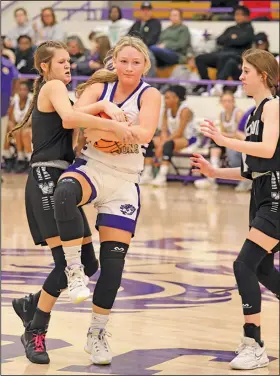  ?? Penny Chanler/Special to the News-Times ?? Battle for the ball: Junction City’s Allie Thurmon tries to hang on to the ball during a game at Junction City earlier this season. The Lady Dragons came away with a 59-56 overtime win at Woodlawn on Monday.