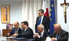  ??  ?? From left, M. Cutajar and Dr L. Busuttil, of SportMalta, J. Pace Bonello and J. Cassar, of the MOC, during the signing of the agreement. Parliament­ary Secretary Chris Agius looks on