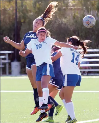  ?? Dan Watson/The Signal (See additional photos on signalscv.com) ?? College of the Canyons forward Corina Sagato (24), left, heads the ball into the goal past Allan Hancock defenders Elizabeth Aldana (10) and Lissette Calderon to score in the first half at COC on Tuesday.