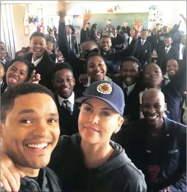  ?? Picture: FACEBOOK ?? CLASS ACT: Trevor Noah and Charlize Theron at Oaklands High School yesterday.