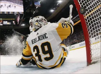  ?? Winslow Townson/Getty Images ?? A shot by Boston’s Pavel Zacha beats goalie Alex Nedeljkovi­c in the third period Saturday to extend the Bruins lead to 5-1 in Boston.