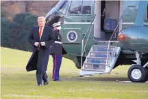  ?? JACQUELYN MARTIN/ASSOCIATED PRESS ?? President Donald Trump exits the Marine One helicopter as he returns to the White House Friday in Washington after speaking at the 2018 Project Safe Neighborho­ods National Conference.