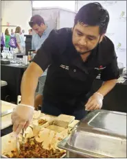  ?? BARRY TAGLIEBER — FOR MEDIANEWS GROUP ?? Chef Jorge Diaz prepares one of many side foods at the Bite for Fight event.