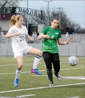  ?? Graham Thomas/Herald-Leader ?? Siloam Springs junior Paige Thompson, left, goes for the ball against Muskogee (Okla.) forward Callie Mayes during Monday’s game at Panther Stadium. The Lady Panthers defeated the Lady Roughers 3-0.