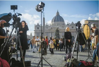  ?? ANTONIO MASIELLO/GETTY IMAGES ?? Journalist­s and reporter gather at St. Peter’s Square after the announceme­nt of the death of former Pope Benedict XVI, on Saturday in Vatican City, Vatican. Joseph Aloisius Ratzinger was born in Marktl, Bavaria, Germany in 1927. He became Pope Benedict XVI, serving from April 19, 2005, until his resignatio­nFeb. 28, 2013.