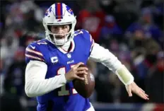  ?? Timothy T Ludwig/Getty Images ?? Bills quarterbac­k Josh Allen threw a franchise playoff-record five touchdown passes in a rout of the Patriots Saturday night.