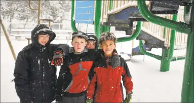  ?? Ben Lambert / Hearst Connecticu­t Media ?? Keith Lleras, 11, Kaleb Casteel, 11, Connor Bennett, 11, and Matteo D’Aniello, 10, all of Torrington, spent their day off from school on the playground at Major Besse Park in Torrington.