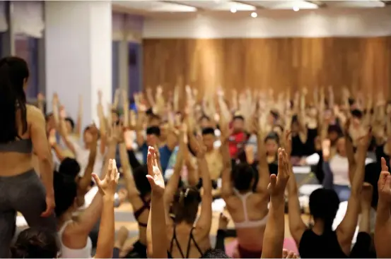  ??  ?? Yoga fans attend Kyle’s training class in Shanghai, where he has been traveling every April and October since 2015. — Ti Gong