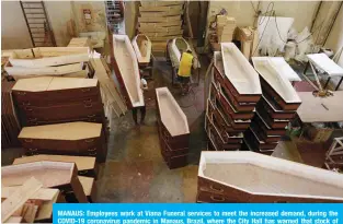  ??  ?? MANAUS: Employees work at Viana Funeral services to meet the increased demand, during the COVID-19 coronaviru­s pandemic in Manaus, Brazil, where the City Hall has warned that stock of coffins in the region is likely to run out.
—AFP