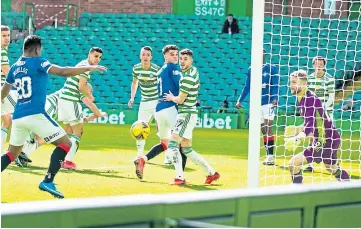  ??  ?? FINALLY: Alfredo Morelos nips in to notch his first goal against Celtic in 15 meetings.