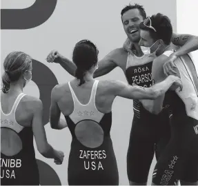  ?? JAMIE SQUIRE/GETTY IMAGES ?? Morgan Pearson celebrates with teammates Katie Zaferes, Kevin McDowell and Taylor Knibb after taking silver in triathlon mixed relay.