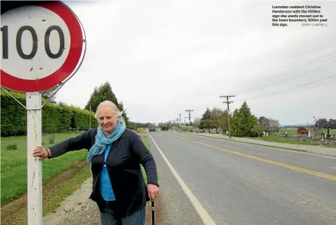  ??  ?? Lumsden resident Christine Henderson with the 100km sign she wants moved out to the town boundary, 500m past this sign. JENNY CAMPBELL