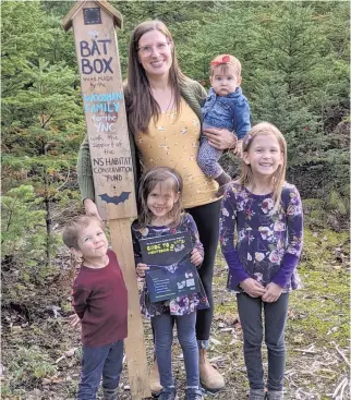  ?? CONTRIBUTE­D ?? Heather Haughn, chapter leader for the South Shore chapter of the Young Naturalist­s Club of Nova Scotia, is shown with her children and a rocket-style bat box. From left is Alder, Heather, Avianna, Maevyn (in her arms), and Zayla.