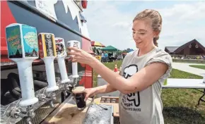  ?? SCOTT ASH/NOW NEWS GROUP ?? City of Glendale employee Anna Voigt taps a Sprecher Root Beer during the second annual Root Beer Bash at Richard E. Maslowski Community Park in Glendale in 2018. This year’s Root Beer Bash is Aug. 28.