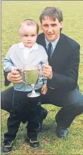  ??  ?? Dougie holds a trophy as a youngster with his dad