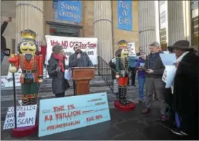  ?? PETE BANNAN – DIGITAL FIRST MEDIA ?? June Palmer of Concerned Citizens Berks County and Luke Bauerlein of Indivisibl­e Chester County sing anti-tax bill carols at a protest on the steps of the Historic Chester County Courthouse to urge U.S. Rep. Ryan Costello to vote ‘no’ on the GOP tax...