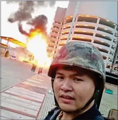  ??  ?? Thomma poses for a selfie by the explosion he caused CARNAGE: