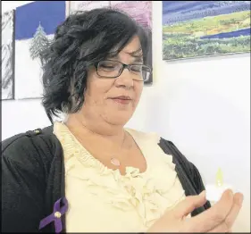  ?? LYNN CURWIN/TRURO DAILY NEWS ?? Bev Walker, program supervisor at the Mi’kmaq Family Healing Centre, in Millbrook, looks at one of the lights turned on in memory of women who lost their lives to violence.