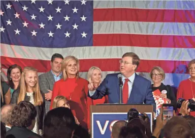  ?? SARAH WARNOCK/CLARION LEDGER ?? Surrounded by family and friends in the ballroom of the Westin Hotel in downtown Jackson, Miss., Tate Reeves gives a victory speech to his supporters. Reeves won the Mississipp­i gubernator­ial race against Democratic candidate Jim Hood on Tuesday.