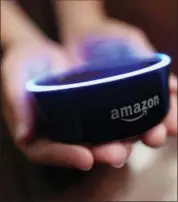 ?? MIKE STEWART — THE ASSOCIATED PRESS ?? A child holds his Amazon Echo Dot in Kennesaw, Ga. Amazon updated its voice assistant with a feature that can make Alexa more kid-friendly. When the FreeTime feature is activated, Alexa answers certain questions differentl­y.