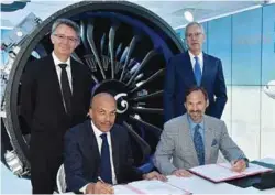  ??  ?? FIRM ORDERS: (LEFT) AIRASIA AND AIRBUS ANNOUNCED AN ORDER FOR 100 A321NEO AIRCRAFT, BRINGING THE TOTAL NUMBER OF A320 FAMILY AIRCRAFT ORDERED BY AIRASIA TO 575. (RIGHT) CFM PRESIDENT AND CEO JEAN-PAUL EBANGA AND AWAS CEO PETER SIEGEL SIGNED AN...