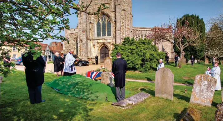  ??  ?? Far apart: Numbers were restricted for this funeral in Thaxted, Essex