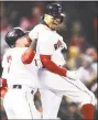  ?? Maddie Meyer / Getty Images ?? The Red Sox’s Mookie Betts, right, celebrates with Brock Holt after hitting a grand slam during the sixth inning against the Yankees Tuesday at Fenway Park.