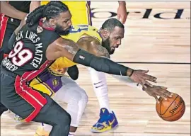  ??  ?? L e BRON JAMES battles Jae Crowder for a loose ball in Orlando. Before the game, James texted his Lakers teammates on the importance of winning Game 4.