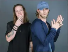  ??  ?? Tyler Hubbard, left, and Brian Kelley of Florida Georgia Line pose for a portrait in New York to promote their latest album, “Dig Your Roots.”