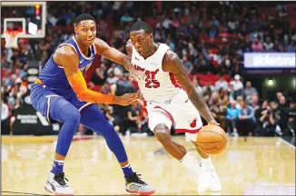  ??  ?? Miami Heat guard Kendrick Nunn (25) drives past New York Knicks forward R.J. Barrett during the second half of
an NBA basketball game on Dec 20, in Miami. (AP)