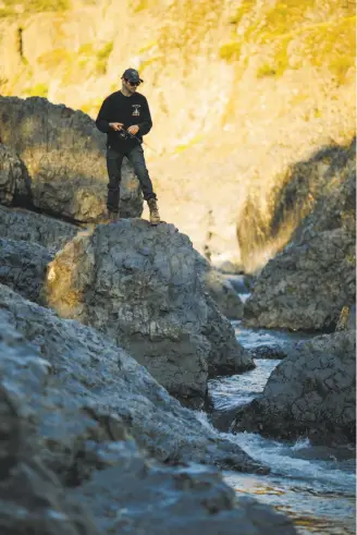  ?? Mason Trinca / Special to The Chronicle ?? Jade Brewer fishes in Upper Bidwell Park’s Big Chico Creek in Chico, a city that also boasts a Cal State campus and a huge park with features from playground­s to rugged gorges.