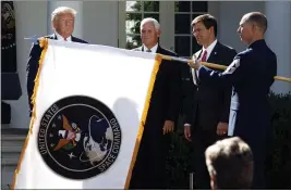  ?? CAROLYN KASTER — THE ASSOCIATED PRESS FILE ?? President Donald Trump watches with Vice President Mike Pence and Defense Secretary Mark Esper as the flag for U.S. space Command is unfurled in the Rose Garden of the White House in Washington on Aug. 29, 2019.