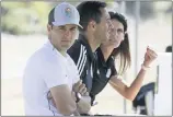  ?? GREGORY BULL — THE ASSOCIATED PRESS FILE ?? San Diego Loyal coach Landon Donovan, left, sits next to assistant coaches Nate Miller, center, and Carrie Taylor during a March scrimmage in Chula Vista , Calif.