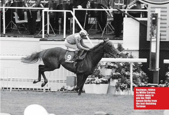  ??  ?? Nashwan, ridden by Willie Carson, strides away to win the 1989 Epsom Derby from the fast-finishing Terimon