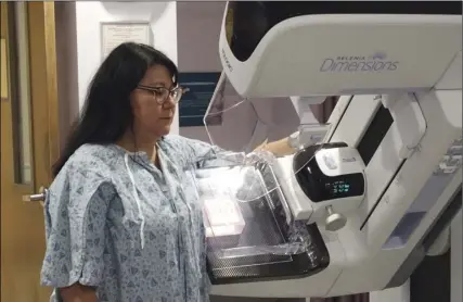  ?? PHOTO ANDY VELEZ ?? Pioneers Memorial Healthcare District employee and former patient Betty Guerra participat­es in a demonstrat­ion of the district’s new 3D mammogram technology Thursday morning.