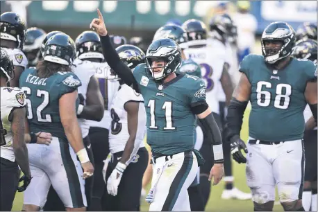  ?? THE ASSOCIATED PESS ?? Eagles quarterbac­k Carson Wentz, center, celebrates after scoring a touchdown in the fourth quarter. Wentz had a huge second half, but it wasn’t enough as the Eagles dropped a 30-28 decision to the Baltimore Ravens Sunday at Lincoln Financial Field.