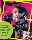  ?? ?? American rapper
Lil’ Kim made a statement in a bright pink feather around her neck as she performed at the
music fest